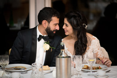 Greek wedding couple smiling at eachother